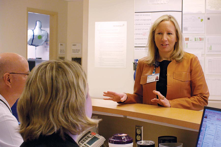 Christina Freese Decker talks with employees at Corewell Health